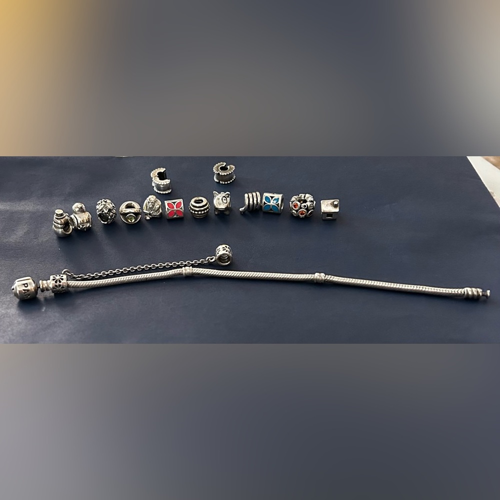 Silver Pandora bracelet with 12 charms and 2 spacers